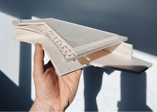 Hand holding a architectural model of Dusty Miller house